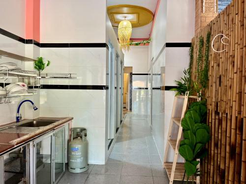 a kitchen with a sink and a counter at T'H Homestay in Mui Ne