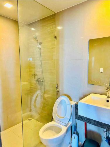 a bathroom with a shower and a toilet and a sink at Mactan Newtown By The Beach in Lapu Lapu City