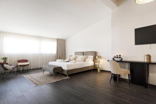 a living room with a bed and a tv at Petraianca Panoramic BH in Marina di Ragusa