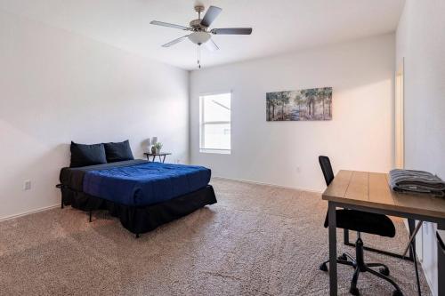 a bedroom with a bed and a desk and a ceiling fan at Contemporary Austin Home Near Downtown & Airport in Austin