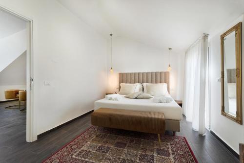 a bedroom with a large bed and a rug at Petraianca Panoramic BH in Marina di Ragusa
