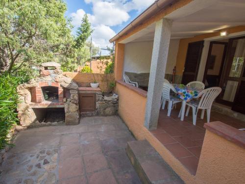 a patio with a stone fireplace on a house at Casa vacanze Rugiada Porto Pollo in Porto Pollo