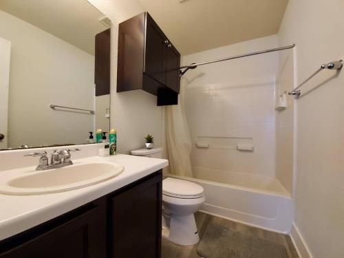 a bathroom with a sink and a toilet and a shower at Cozy Home Near Downtown Austin And Airport in Austin