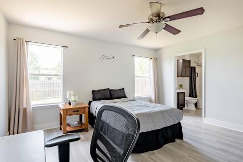 a bedroom with a bed and a ceiling fan at Serenity Home Near Downtown & Airport in Austin