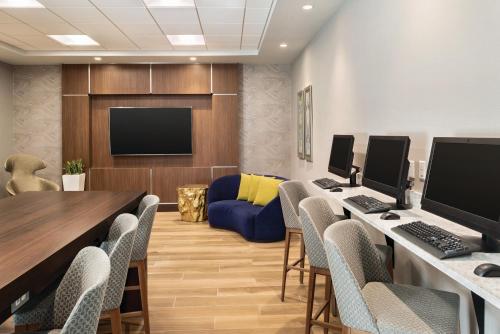 a conference room with a table and chairs and a couch at Embassy Suites by Hilton Indianapolis Downtown in Indianapolis