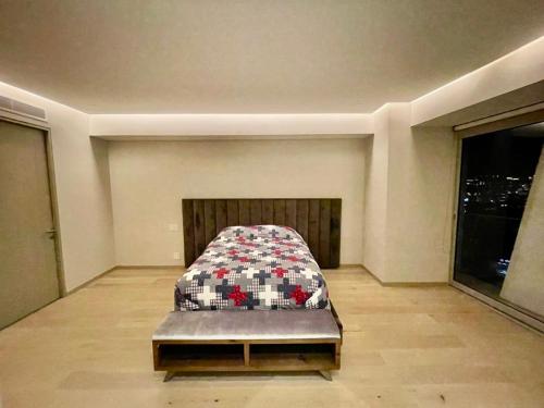 a bedroom with a bed in a room at Departamento B, Santa Fe, Piso 42 in Mexico City