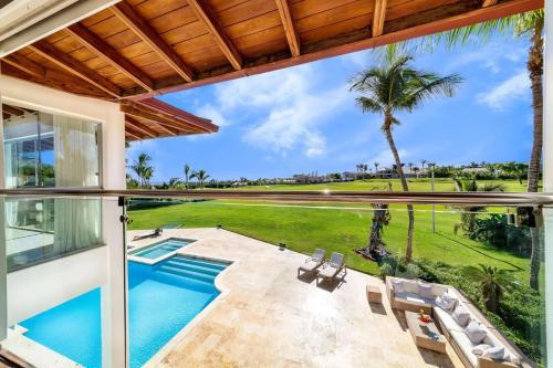 a view from the balcony of a house with a swimming pool at Casa de Campo Elegance - 8-Bedroom Golf View Villa in La Romana