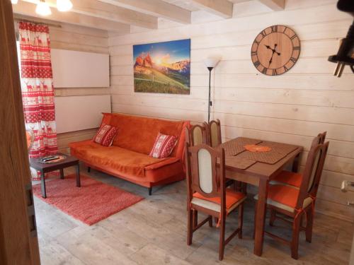 a living room with a couch and a table at Domki pod Pilskiem in Korbielów