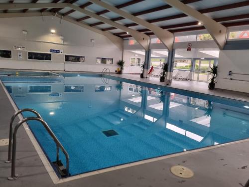 a large indoor swimming pool with blue water at Chalet Brightstone Kingsdown Cliffs location with indoor pool, tennis court, mini-golf short walk to beach and 3 great local pubs in Kingsdown