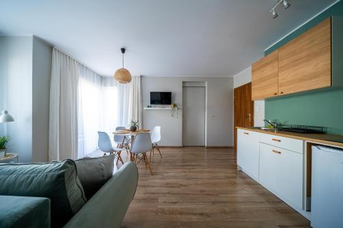 a kitchen and living room with a couch and a table at VERTUS in Jastrzębia Góra