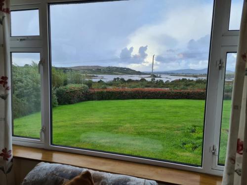 a window with a view of a yard at Tigh Mhartin in Glentrasna