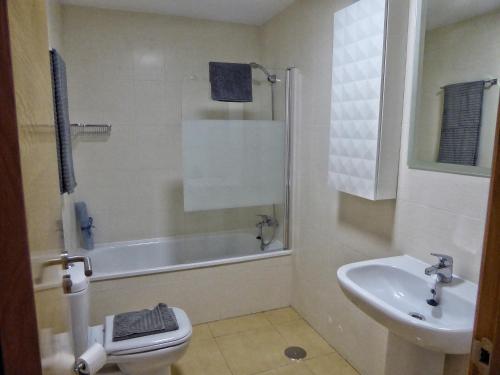 a bathroom with a toilet and a sink at Mar Menor Golf 2 Free Pool, Padel tennis, Gym Yoga etc in Murcia