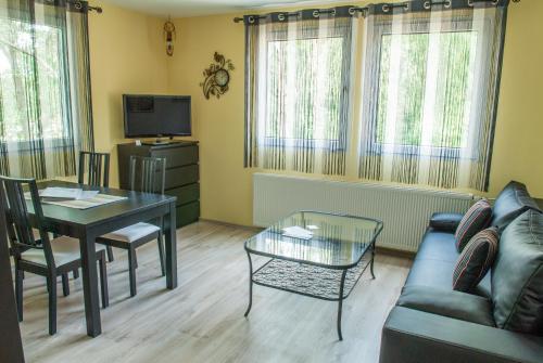 a living room with a table and a couch at Pension Traumfänger in Friedland