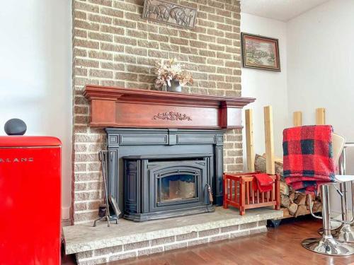 a fireplace in a living room with a brick wall at Spacious 5BR home. Close to everything! in Gatineau