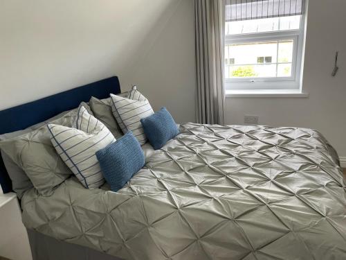 a large bed with pillows on it in a bedroom at The Herb Garden in Great Carlton