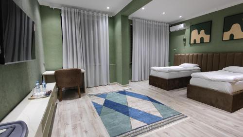 Katil atau katil-katil dalam bilik di Calipso Dushanbe Hotel