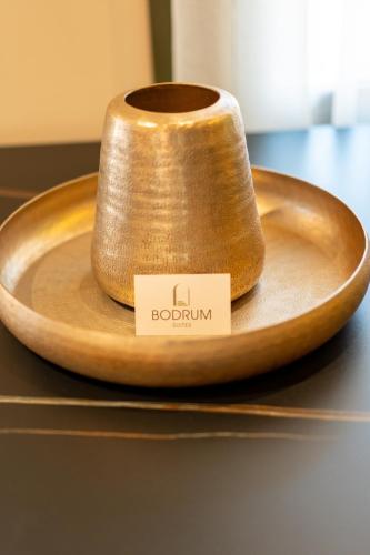 a wooden bowl with a roll of toilet paper on a table at Bodrum Suites in Ioannina