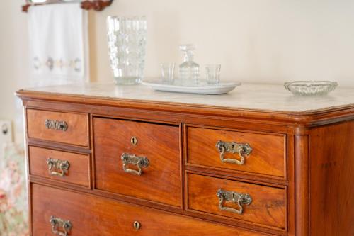 a wooden dresser with a plate on top of it at Anna's Cozy Home in Argostoli