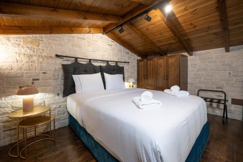 a bedroom with a large white bed in a room at Bodrum Suites in Ioannina