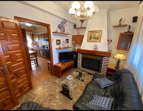 a living room with a couch and a fireplace at Casa VENTA RUIZO in Lorca