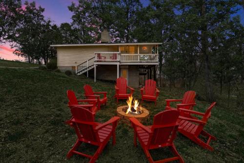 a group of chairs around a fire pit in front of a house at Harpers Ferry Cabin Hot Tub, Deck, Fire Pit, WiFI in Harpers Ferry