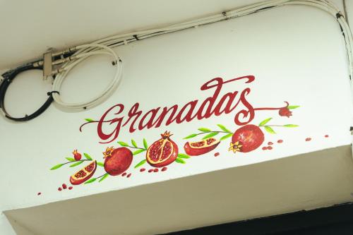 a sign on a wall with pomegranates on it at Casa Don José: GRANADAS in Oaxaca City