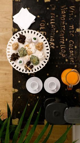a table with a plate of food on it at Castellano suites in Castellammare del Golfo