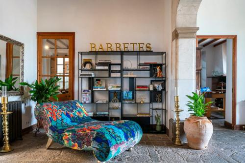 a store with a chair and a book shelf at Ca's Xorc Luxury Retreat - ADULTS ONLY in Sóller