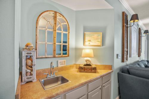a kitchen with a sink and a couch at Palacio 1604 in Pensacola