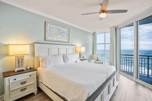 a bedroom with a bed with a view of the ocean at Palacio 1604 in Pensacola