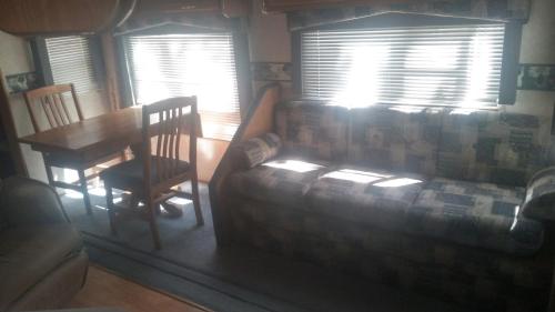a living room with a couch and a table at Two Creeks Camp in Athens
