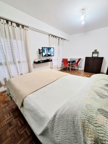 Dormitorio con cama, escritorio y TV en Florida Bedchamber en Buenos Aires