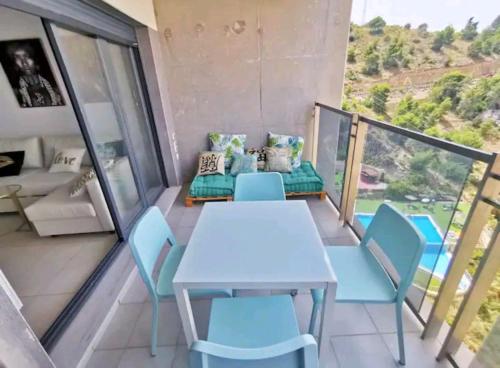 貝尼多姆的住宿－Mirador vistas panorámicas a Benidorm，阳台配有白色的桌椅
