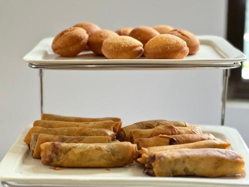 a plate of pastries and rolls on a table at No.33 Lodge in Dar es Salaam