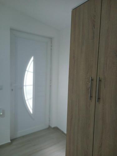 a wooden cabinet in a room with a window at ApHEARTments in Gevgelija