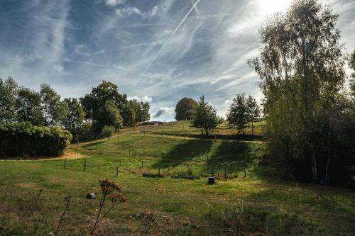 a field with a hill with trees on it at Domaine Abbey-Rose in Champsac