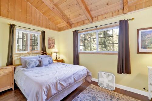 a bedroom with a bed and two windows at Lazy bear lodge #1235 in Big Bear Lake