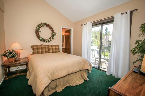 a bedroom with a bed with a wreath on the wall at Boulder creek #1412 in Big Bear Lake