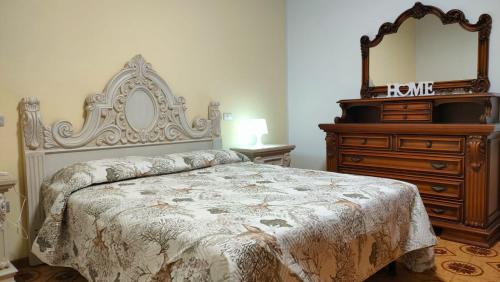 a bedroom with a bed and a dresser and a mirror at A casa di Ilaria in Venturina Terme
