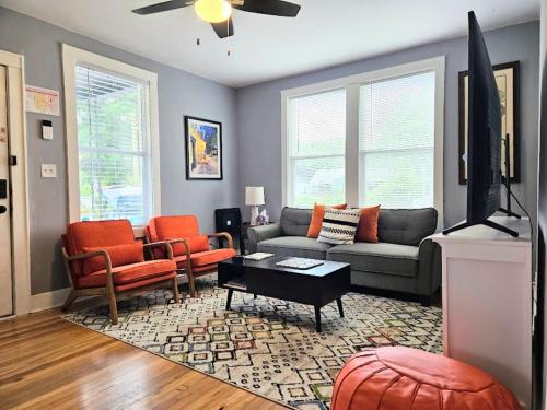 a living room with a couch and two chairs at Dundee Escape in Charleston