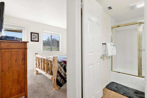 a bedroom with a crib and a mirror at Sunny side up #1343 in Big Bear Lake