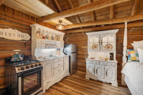 a kitchen with white cabinets and a stove at Spring Hill Farm - The Happy Hound in Alma