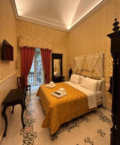 a bedroom with a large bed and a mirror at Carafa di Maddaloni Residenza di Charme in Naples