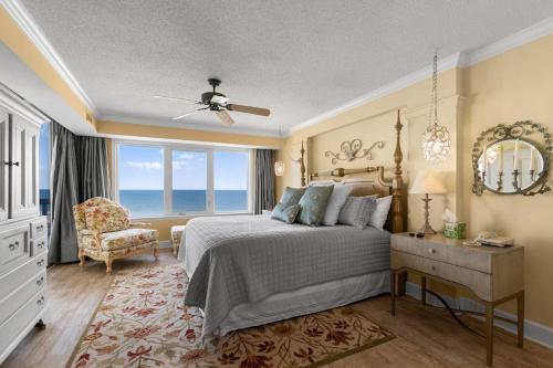 a bedroom with a bed and a chair and a window at Coastal Paradise Getaway 3BR Condo Ocean View in Pawleys Island