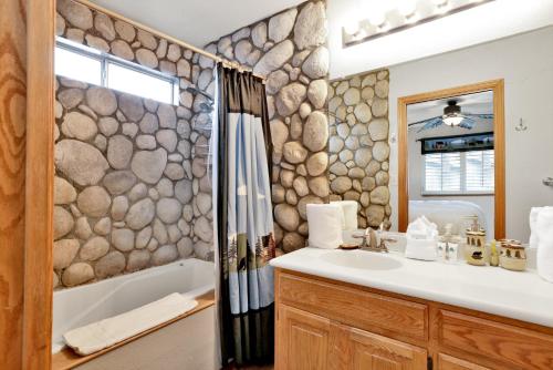 y baño con lavabo, bañera y ducha. en Beardise #2329 en Big Bear City