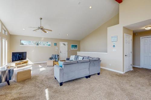 a large living room with a couch and a tv at Beach Escape in Rockaway Beach
