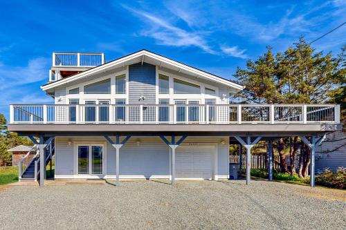 a large white house with a large balcony at Beach Escape in Rockaway Beach