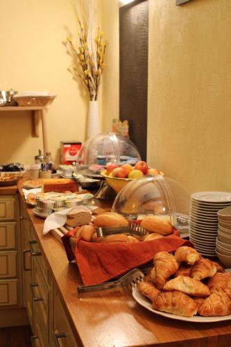 a table with plates of food and bread on it at Hotel Le Jacquemart in Dijon