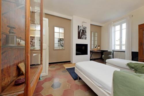 a bedroom with two beds and a tv in a room at Michelangelo Charmsuite in Rome