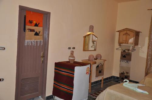 a room with a table and a door in a room at oasis panorama in Bawiti
